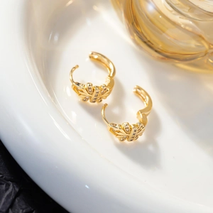 Macro shot of 18K gold plated butterfly hoop earrings with sparkling zircon micro-inlay
