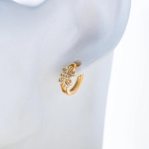 Close-up of 18K gold-plated leaf hoop earrings with cubic zirconia inlay on white model