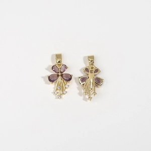 Detail view of gold flower pendants with purple gemstones and shimmering tassels