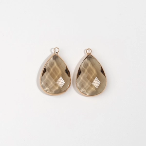 Detail of tear-drop champagne crystal pendants with gold edges for DIY jewelry making