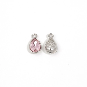 Detailed front and back views of pink teardrop crystal charms with silver hammer texture