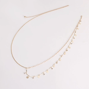 Close-up of golden double-layer waist chain with butterfly charms and shiny rhinestones