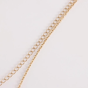 Detailed close-up of dual-layer golden metal waist chain with different sized links