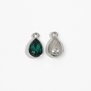 Silver teardrop crystal pendant with dark green gemstone and floral embossed back side