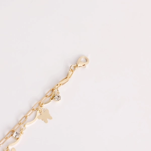 Close-up of gold butterfly pendant and sparkling rhinestones on multi-layer metal waist chain