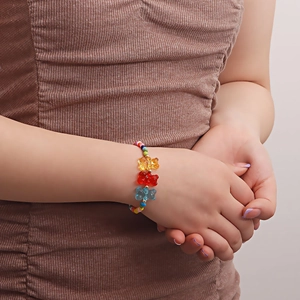 Bohemian colorful beaded bracelet with translucent gummy bear charms on model wrist