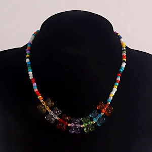 Detailed macro view of colorful beaded necklace with transparent acrylic gummy bear charms