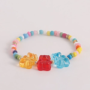 Detail of bohemian colorful beaded bracelet with three transparent resin bear charms