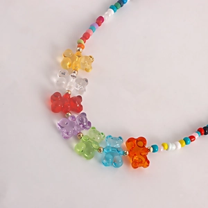 Detail of colorful seed bead necklace with seven translucent resin gummy bear pendants