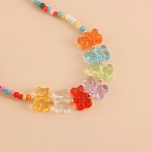 Detailed macro view of bohemian beaded necklace with colorful resin bears and gold spacers