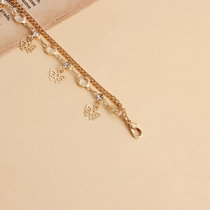 Detail view of double-layer golden butterfly chain with clear crystals and lobster clasp