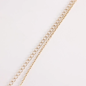 Detail of gold-plated body chain with oval flat links and small circular connectors