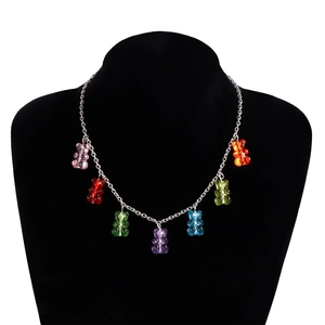 Detail of bohemian necklace featuring seven colorful resin gummy bear pendants on a silver chain