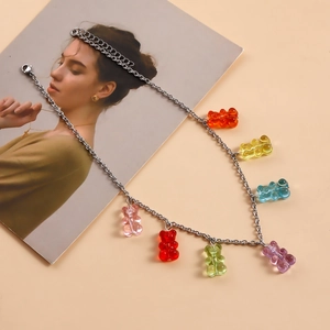 Detail view of colorful resin gummy bears on a silver chain necklace with lobster clasp
