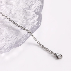 Detailed close-up of a silver cable chain featuring a high-quality lobster clasp closure
