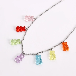 Detail view of colorful resin gummy bear charms on a silver link necklace chain