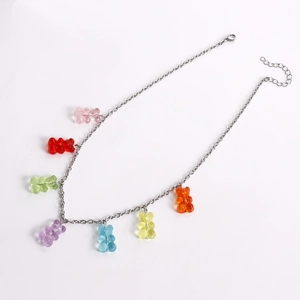 Detail view of silver chain necklace featuring seven colorful resin gummy bear pendants