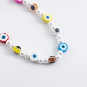 Detail shot of colorful evil eye beads mixed with faux pearls for shoe chains