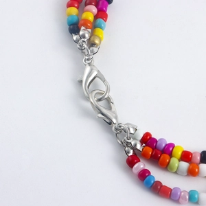 Macro shot of colorful beaded multi-layer shoe chain with silver metal lobster clasps