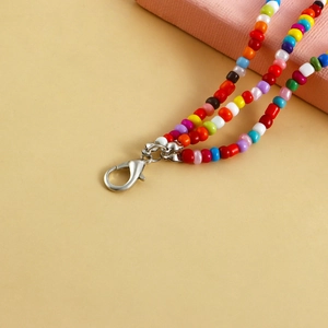 Detailed view of bohemian colorful beaded chain with a polished silver lobster clasp
