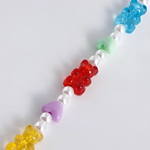 Colorful resin bear and faux pearl bead accessory featuring vibrant heart charms