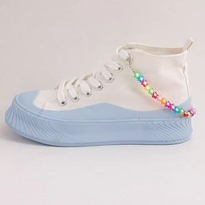 White high-top platform canvas sneakers with light blue sole and colorful star charm chain