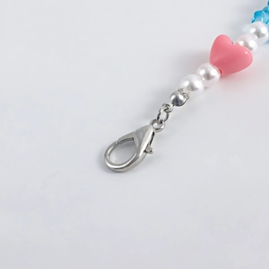Detail of colorful resin heart and star beads with a silver metal lobster clasp