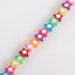 Macro detail of colorful acrylic star-shaped beads for DIY shoe charms and jewelry