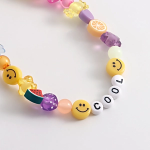 Close-up of colorful handmade shoe chain featuring letter beads and smiley faces