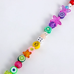 Detail of colorful mixed fruit and smiley face resin beads for custom shoe chain decor