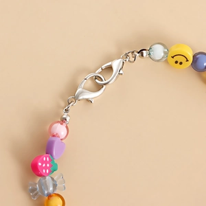 Detail of colorful beaded shoe charms featuring a silver alloy double lobster clasp