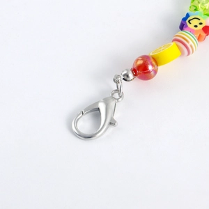 Detail of colorful fruit beaded shoe charm with silver lobster clasp and rainbow beads