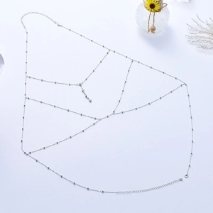 Detail of silver beaded multi-layer body chain with delicate metallic texture and lobster clasp