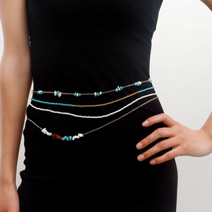Bohemian multilayer waist chain featuring turquoise beads on a minimalist black dress
