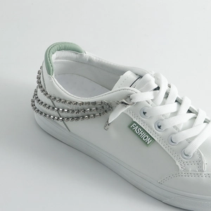White leather sneakers with triple layered rhinestone chains and green fashion label