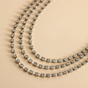 Close-up of triple-layered silver claw chain with sparkling crystals for shoes and jewelry