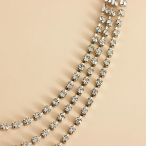 Close-up of triple-layered silver claw-set rhinestone chains for high-end shoe accessories