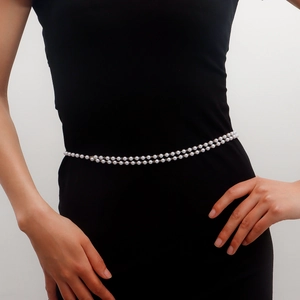 Double-layered faux pearl waist chain with gold alloy link on black slim dress
