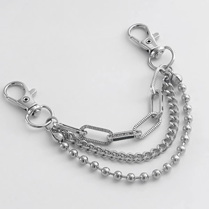 Close-up of triple-layered silver metal chain with lobster clasps and beaded textures