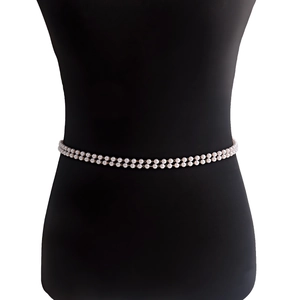 Elegant double-layered faux pearl waist chain for women with golden metal accents on mannequin