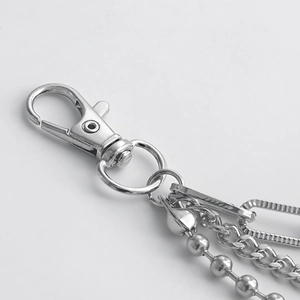 Macro view of silver metal layered shoe chains with lobster clasp and beaded textures