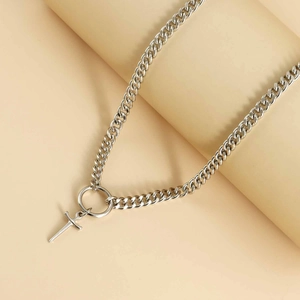 Silver Cuban chain choker with circular ring and cross pendant in minimalist punk style