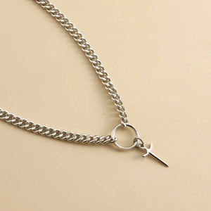 Detailed close-up of a silver Cuban link chain necklace with a cross sword pendant