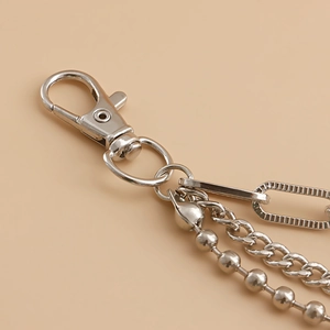 Detail of silver metal accessory featuring lobster clasp and triple layered chains