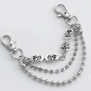 Detailed view of silver skull charm and rhinestone layers on punk style shoe chain accessory