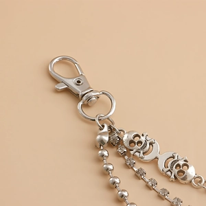 Detail of silver shoe chain with skull charms, bead chain and rhinestone accents