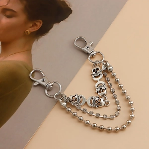 Three-layer silver shoe chain with skull charms, rhinestones and bead chain links