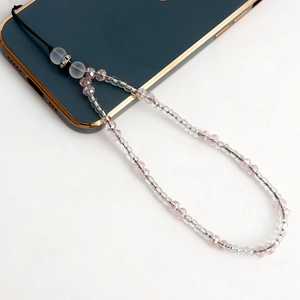 Detail of pink crystal and transparent beaded phone strap with frosted white accents