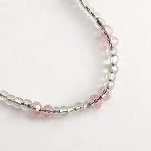 Detailed macro view of pink crystal beads and silver tubes on a fashion phone charm strap