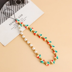 Detail of colorful rainbow heart beads and pearls on a stylish handmade phone lanyard charm